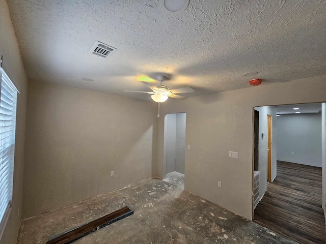 unfurnished room featuring ceiling fan, a textured ceiling, and visible vents