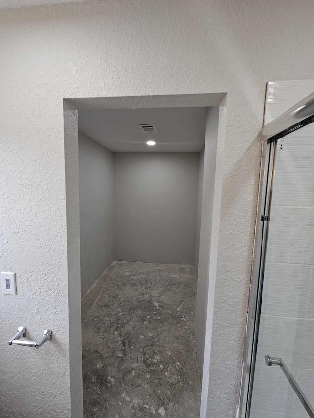 interior space with a textured wall and visible vents