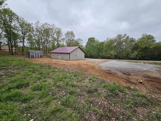 view of yard featuring an outbuilding and a storage shed