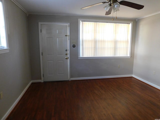 entryway with ornamental molding, wood finished floors, and a healthy amount of sunlight
