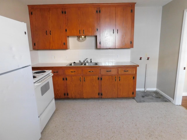 kitchen featuring brown cabinets, backsplash, a sink, and white appliances