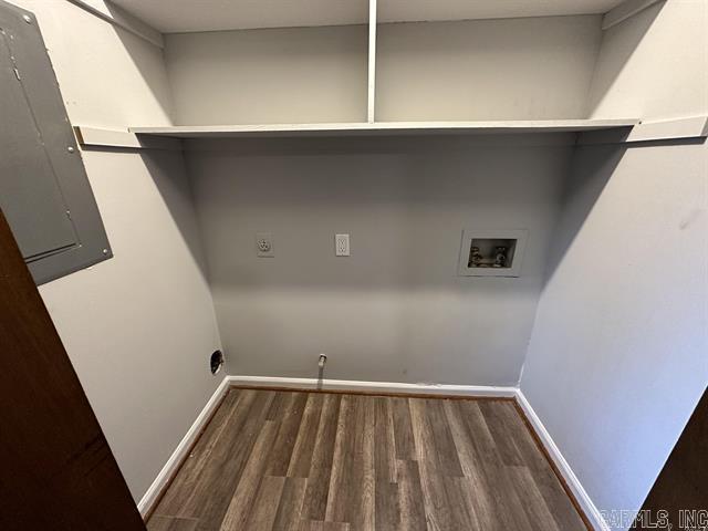 laundry room featuring wood finished floors, electric panel, hookup for a washing machine, and laundry area