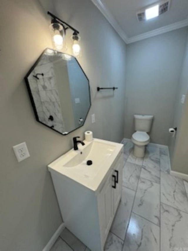 bathroom featuring toilet, baseboards, marble finish floor, vanity, and ornamental molding