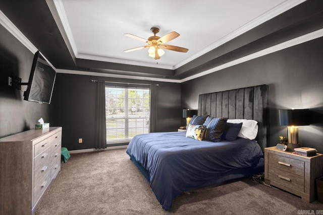 bedroom with a ceiling fan, baseboards, carpet flooring, crown molding, and a raised ceiling