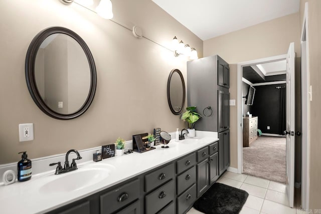 full bathroom featuring double vanity, tile patterned flooring, and a sink