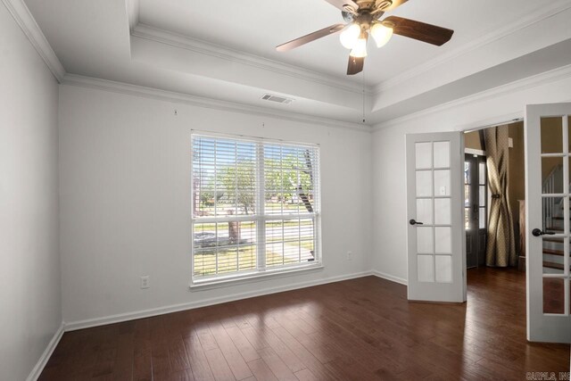 unfurnished room with hardwood / wood-style flooring, french doors, visible vents, a raised ceiling, and baseboards