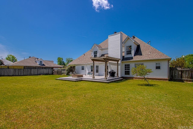 back of property with a yard, a chimney, a pergola, a wooden deck, and a fenced backyard