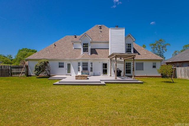 rear view of property with an outdoor fire pit, a pergola, fence, a shingled roof, and a yard