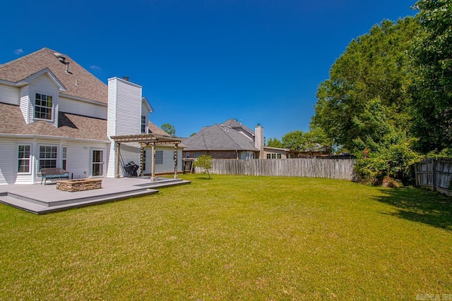 view of yard featuring a pergola, a deck, and a fenced backyard