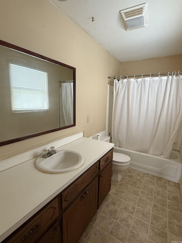 bathroom featuring shower / tub combo with curtain, toilet, and vanity