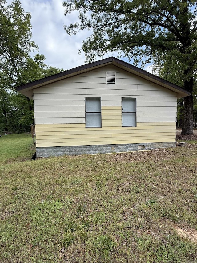 view of side of home featuring a lawn