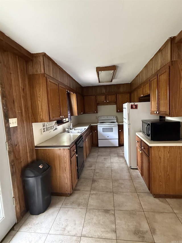 kitchen with light tile patterned floors, brown cabinets, and black appliances