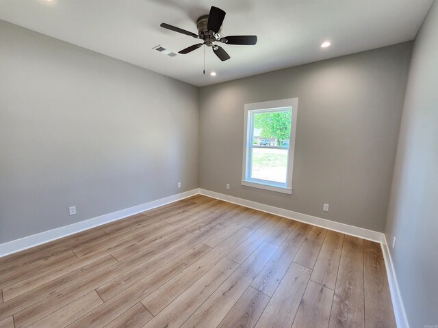 290 Walker St, Higginson, AR 72068 - unfurnished room with wood finished floors, visible vents, baseboards, and ceiling fan