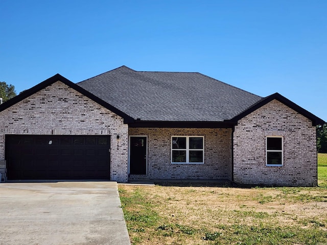 290 Walker St, Higginson, AR 72068 - view of front of home with brick siding, an attached garage, a front yard, and driveway