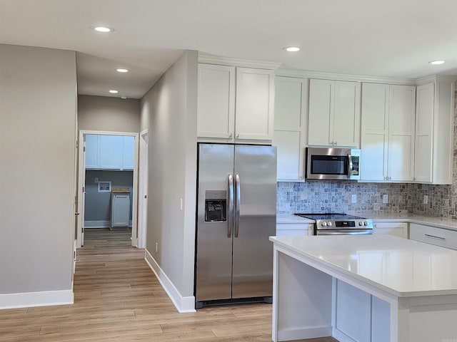 290 Walker St, Higginson, AR 72068 - kitchen with baseboards, stainless steel appliances, light wood finished floors, and light countertops