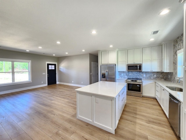 290 Walker St, Higginson, AR 72068 - kitchen with a center island, a sink, visible vents, light countertops, and appliances with stainless steel finishes