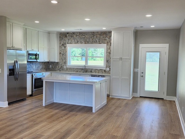 290 Walker St, Higginson, AR 72068 - kitchen with light countertops, light wood finished floors, appliances with stainless steel finishes, and a center island