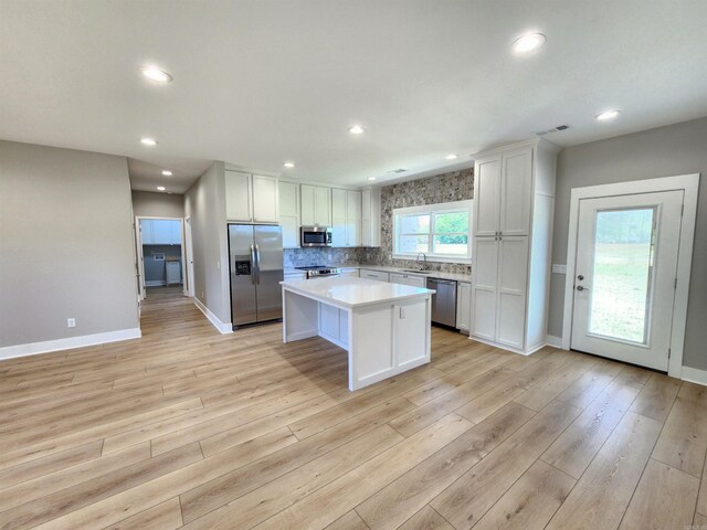 290 Walker St, Higginson, AR 72068 - kitchen featuring white cabinets, a sink, visible vents, a kitchen island, and appliances with stainless steel finishes