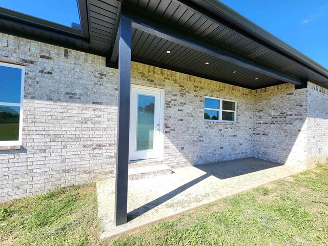 290 Walker St, Higginson, AR 72068 - view of property exterior featuring brick siding and a patio area