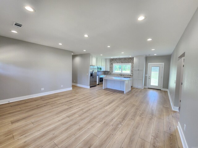 290 Walker St, Higginson, AR 72068 - unfurnished living room with baseboards, light wood finished floors, visible vents, and recessed lighting