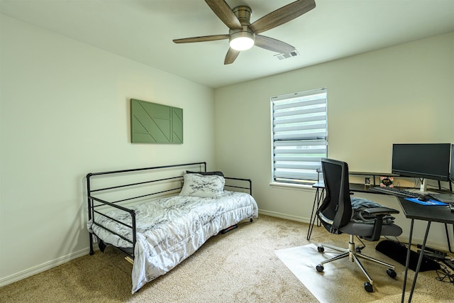 carpeted bedroom with baseboards, a ceiling fan, and visible vents