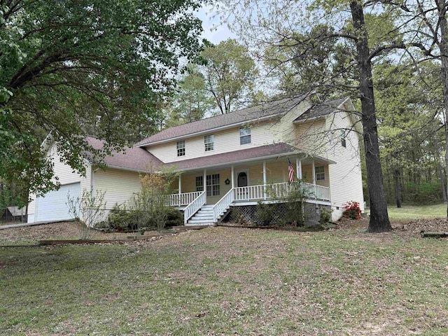 view of front of property with a porch, an attached garage, and a front yard