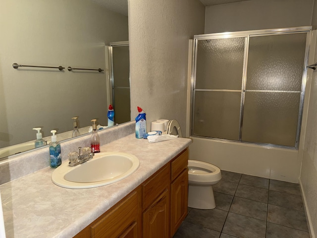 full bath with shower / bath combination with glass door, tile patterned flooring, toilet, and vanity