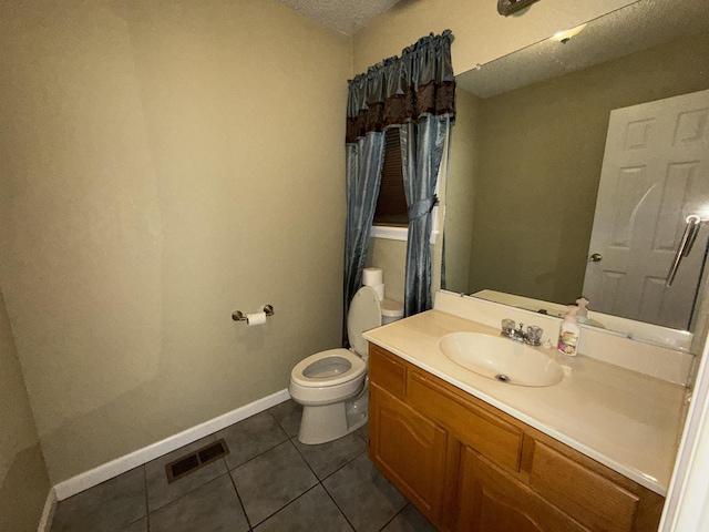 bathroom with tile patterned floors, toilet, baseboards, visible vents, and vanity