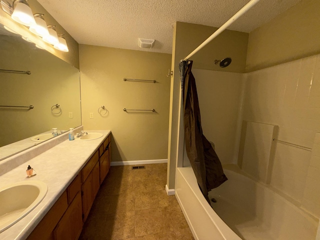 full bathroom with shower / bath combo with shower curtain, a sink, visible vents, and a textured ceiling