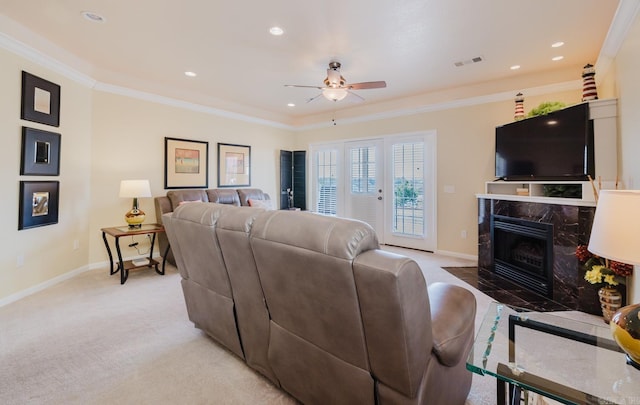 living room featuring ceiling fan, light carpet, visible vents, and baseboards