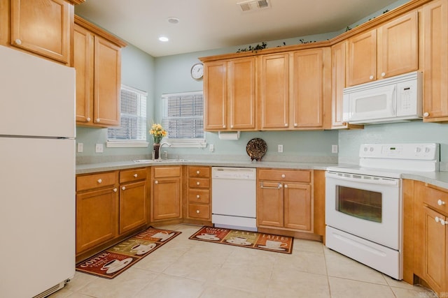 kitchen with a sink, white appliances, light countertops, visible vents, and recessed lighting