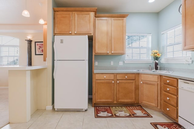 kitchen with light countertops, white appliances, a sink, and light tile patterned flooring