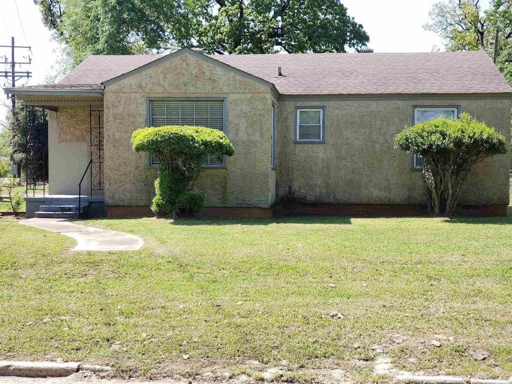 226 Rutherford, Pine Bluff, AR 71601 - back of house with a lawn, a shingled roof, and stucco siding