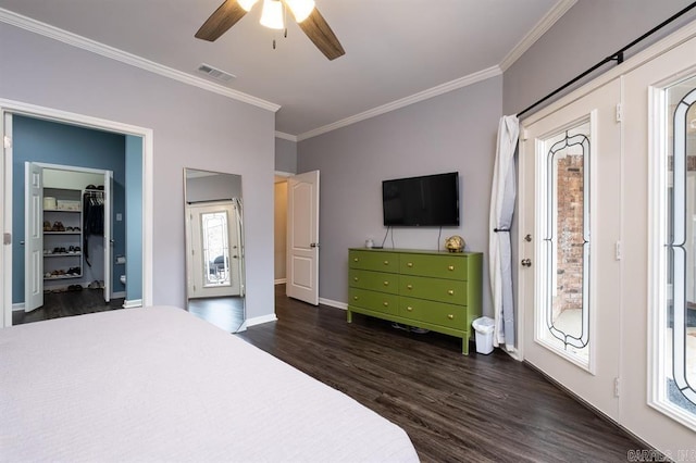 bedroom with dark wood finished floors, visible vents, ornamental molding, baseboards, and ceiling fan