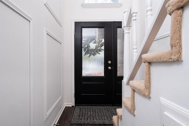 doorway featuring dark wood finished floors and stairway