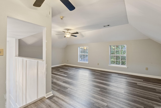 additional living space with vaulted ceiling, visible vents, baseboards, wood finished floors, and ceiling fan
