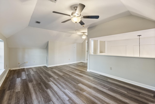 bonus room with lofted ceiling, visible vents, a ceiling fan, dark wood-type flooring, and baseboards