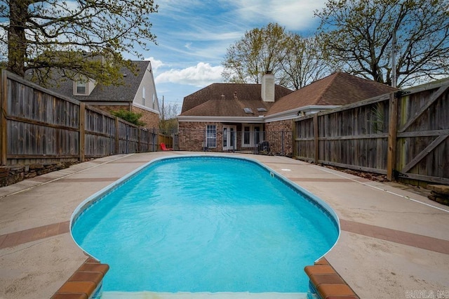 view of swimming pool with a fenced backyard and a fenced in pool