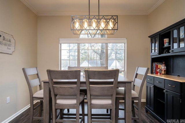 dining space featuring baseboards, dark wood-type flooring, and crown molding