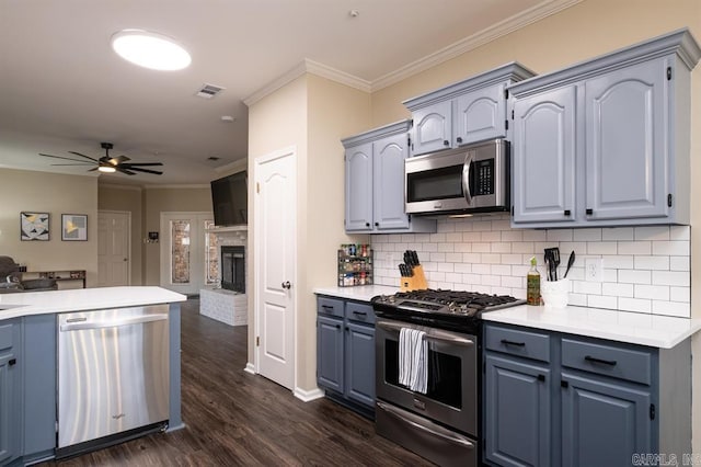 kitchen with backsplash, visible vents, a ceiling fan, crown molding, and appliances with stainless steel finishes