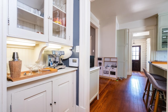 interior space featuring backsplash and dark wood finished floors