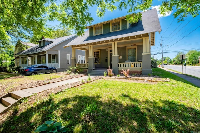 bungalow-style house with a front yard and covered porch