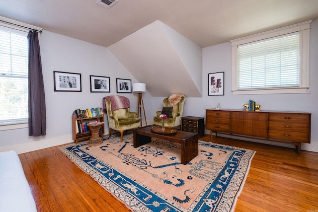 sitting room featuring baseboards, a healthy amount of sunlight, wood finished floors, and visible vents