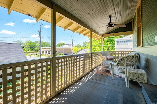 wooden deck featuring a ceiling fan