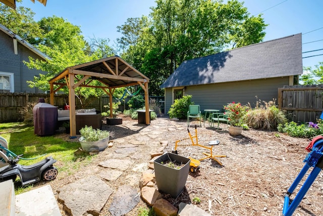 view of patio / terrace featuring a fenced backyard, a gazebo, and an outdoor living space