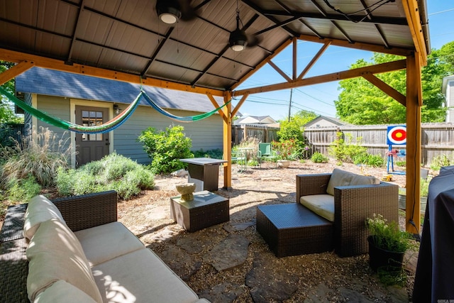 view of patio with a fenced backyard, an outdoor living space, and a ceiling fan