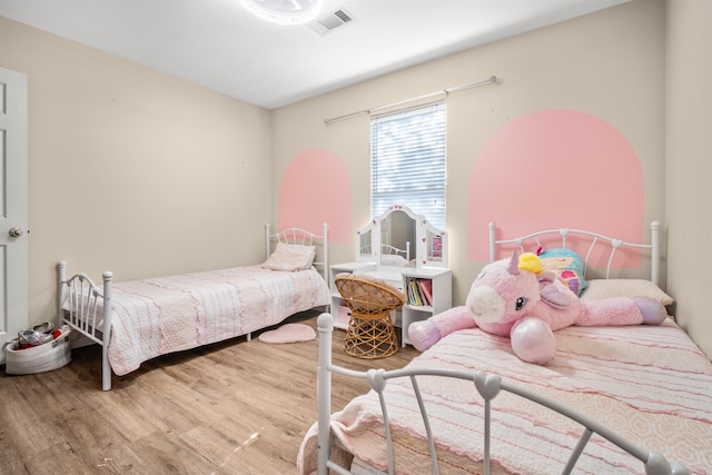 bedroom with wood finished floors and visible vents