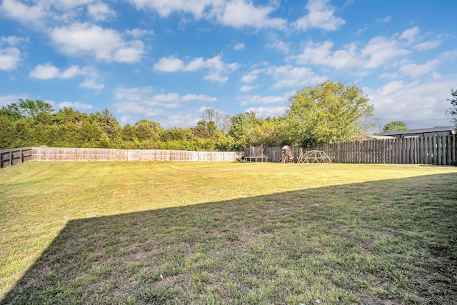 view of yard featuring a fenced backyard and a trampoline