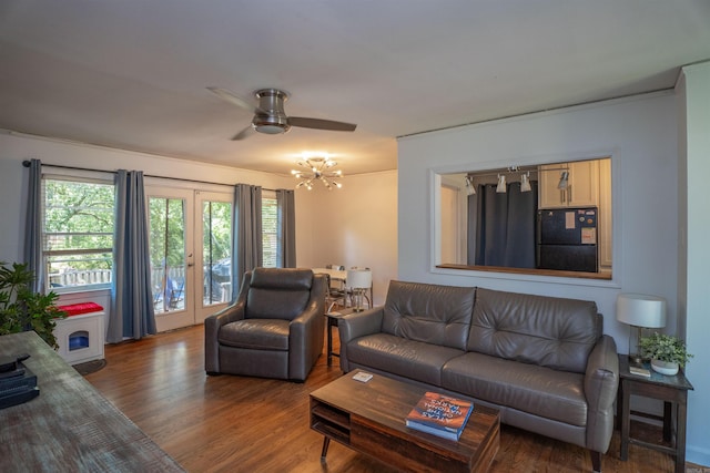 1020 Pine Valley Rd, Little Rock, AR 72207 - living area with wood finished floors, french doors, and ceiling fan with notable chandelier