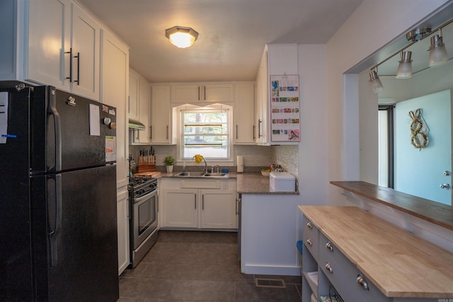 1020 Pine Valley Rd, Little Rock, AR 72207 - kitchen with a sink, freestanding refrigerator, white cabinetry, butcher block counters, and stainless steel gas stove